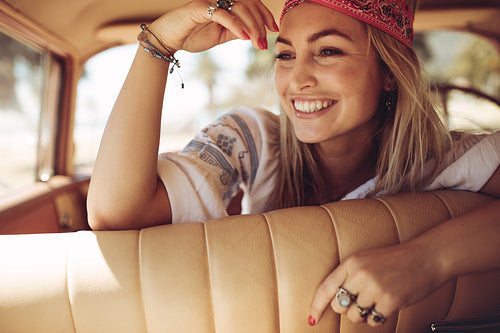 Cheerful woman sitting in a car