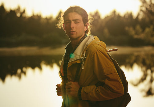 Close up of a man standing near a lake