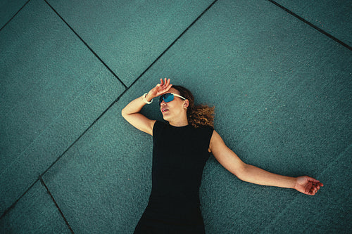 The recovery after running leaves a woman lying on the ground outdoors