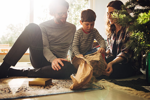 Family having fun opening Christmas gifts