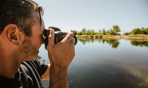 Wildlife photographer taking pictures of a lake