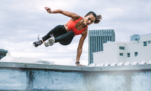 Fitness woman doing workout on rooftop