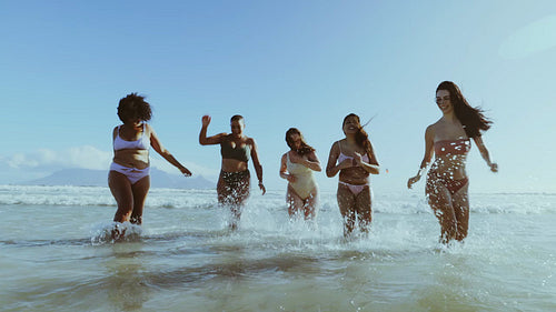 Multiracial female friends enjoying on beach vacation
