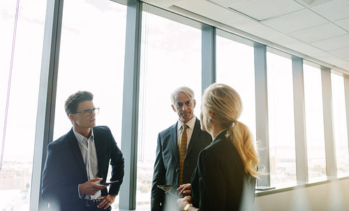 Corporate professional talking about work in office