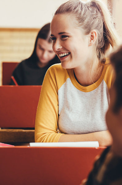 Smiling girl sitting in classroom