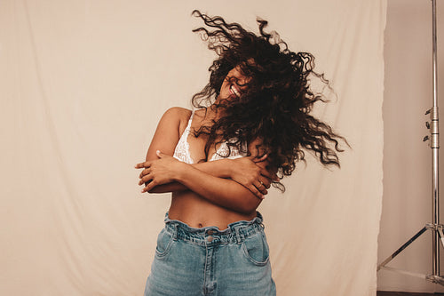 Woman whipping her hair in a studio