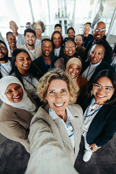 Happy company staff taking a group selfie at the office