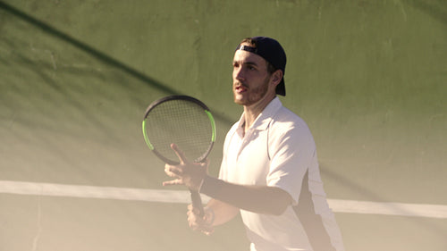 Man playing tennis on a hardcourt