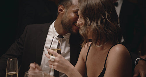 Beautiful couple flirting at gala dinner party