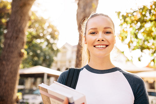 Beautiful college student smiling outdoors