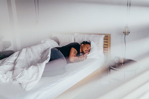 African man sleeping in bedroom with woman