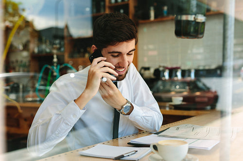Businessman doing his work sitting at a coffee shop