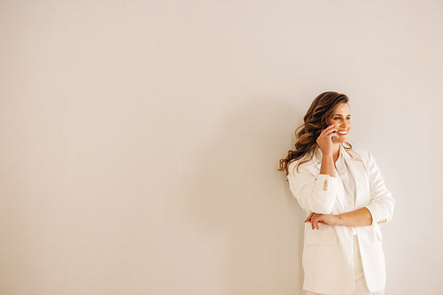 Cheerful businesswoman talking on the phone in an office