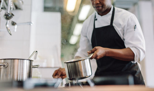 Chef cooking food at restaurant kitchen