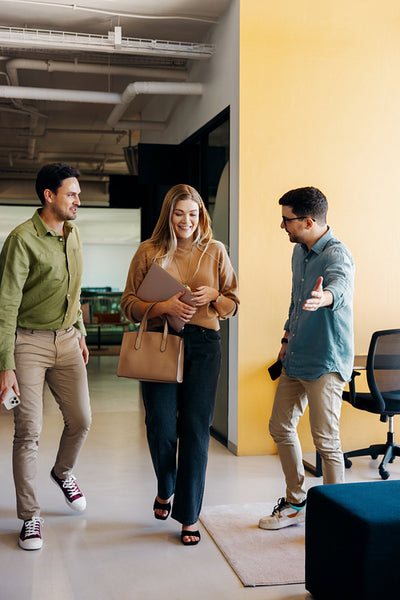 Coworkers having a friendly discussion in a modern office environment