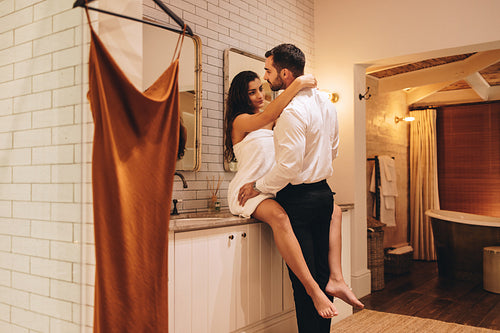 Glamorous young couple getting dressed for an event