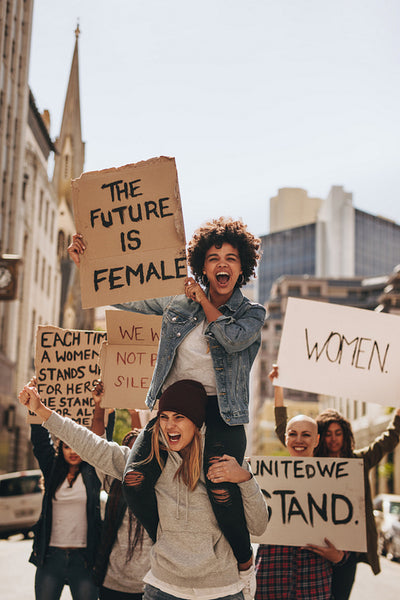 Women enjoying during a demonstration on road