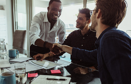 Three businessmen sealing a deal