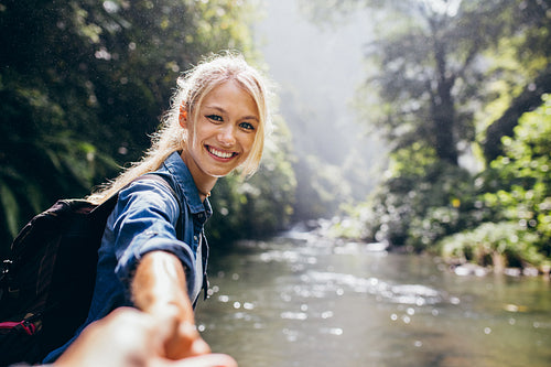 Female hiker holding the hand of her boyfriend
