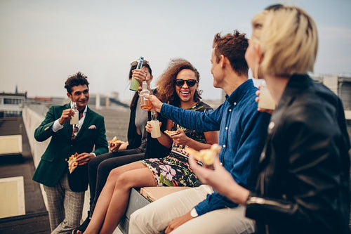 Group of young adults drinking outdoors