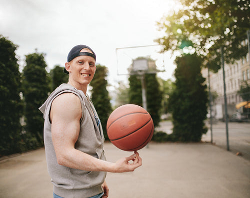 Teenage streetball player spinning the ball