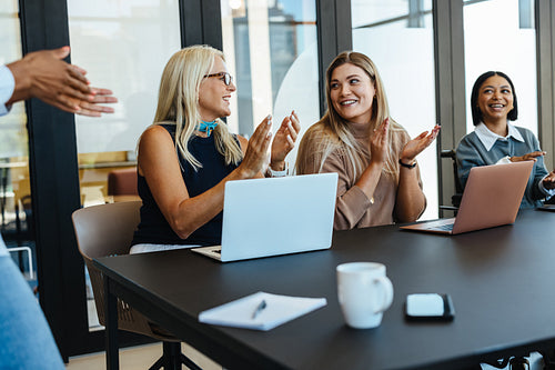 Confident business team celebrating success during an effective meeting in the office