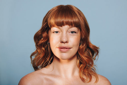Portrait of a woman with ginger hair looking at the camera