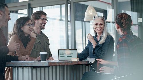 Group of business people having casual talk during meeting