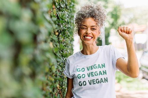 Smiling vegan activist advocating for veganism