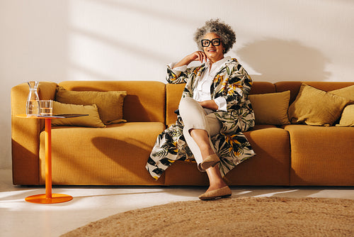Senior businesswoman sitting on a couch in an office lobby