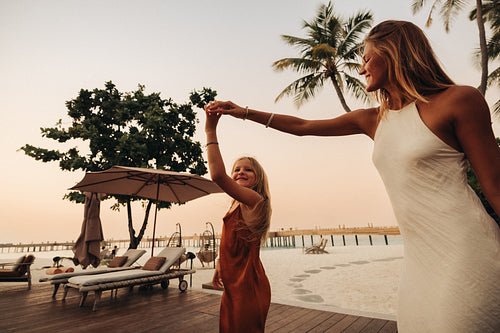 Mother and daughter holding hands at a vacation resort