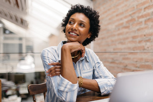 Female entrepreneur looking away thoughtfully in a warehouse
