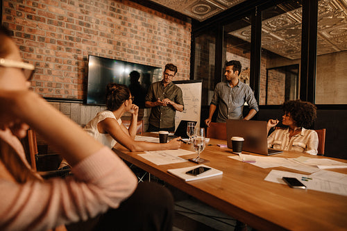 Mixed race people meeting in office