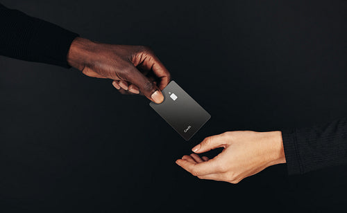 Private banking in the palm of your hand: Black credit card exchange between a man and woman
