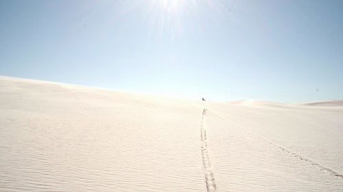Fast motocross racer riding a dirt bike on sand dunes