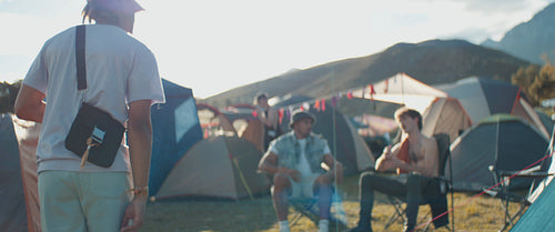 Young male friends greeting each other at a music festival