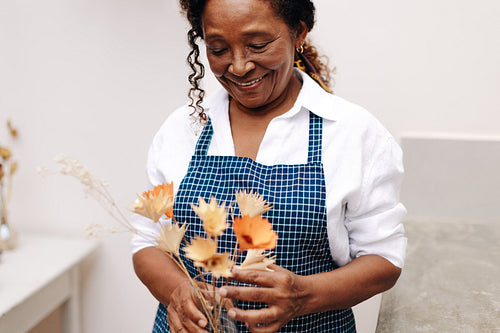 Creative flower crafting: A mature business woman's work