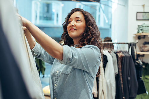 Woman shopping in a fashion clothing store