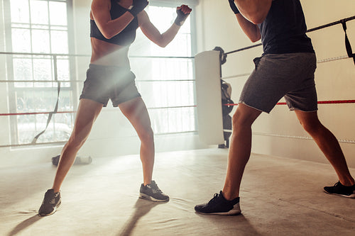 Low angle view of two young boxers fighting in a boxing ring