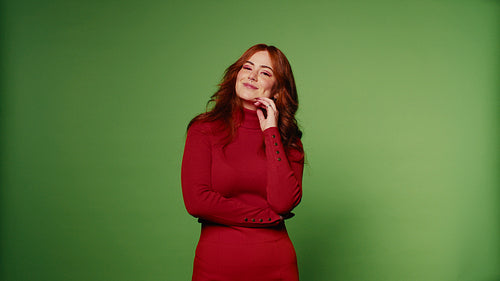 Happy young woman smiling and laughing on green screen background