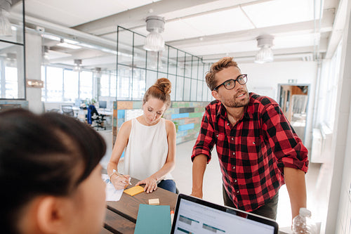 Startup executives meeting around a table.