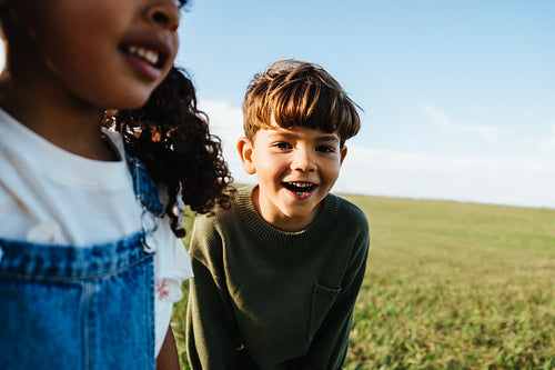 Young girl and boy outdoors smiling