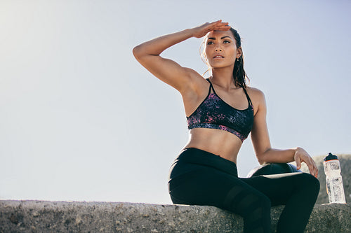Female athlete relaxing after exercise