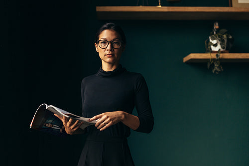 Strong independent business woman with magazine