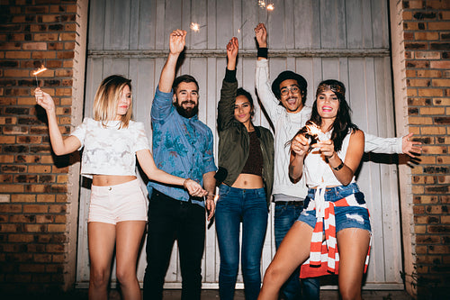Young friends with sparkles enjoying in a party