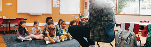 Man teaching an elementary school class using a digital tablet