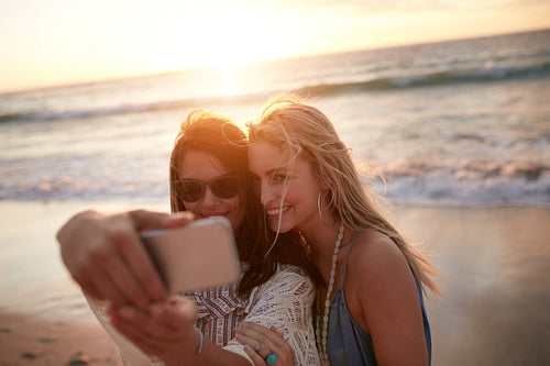 Two female friends taking a selfie at the beach