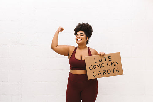 Healthy woman with "Fight like a girl" signboard