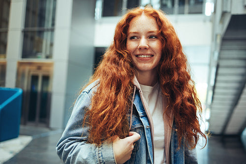 Smiling female student in college campus