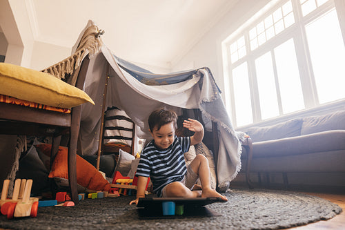 Sweet little boy watching a kids programme on a tablet